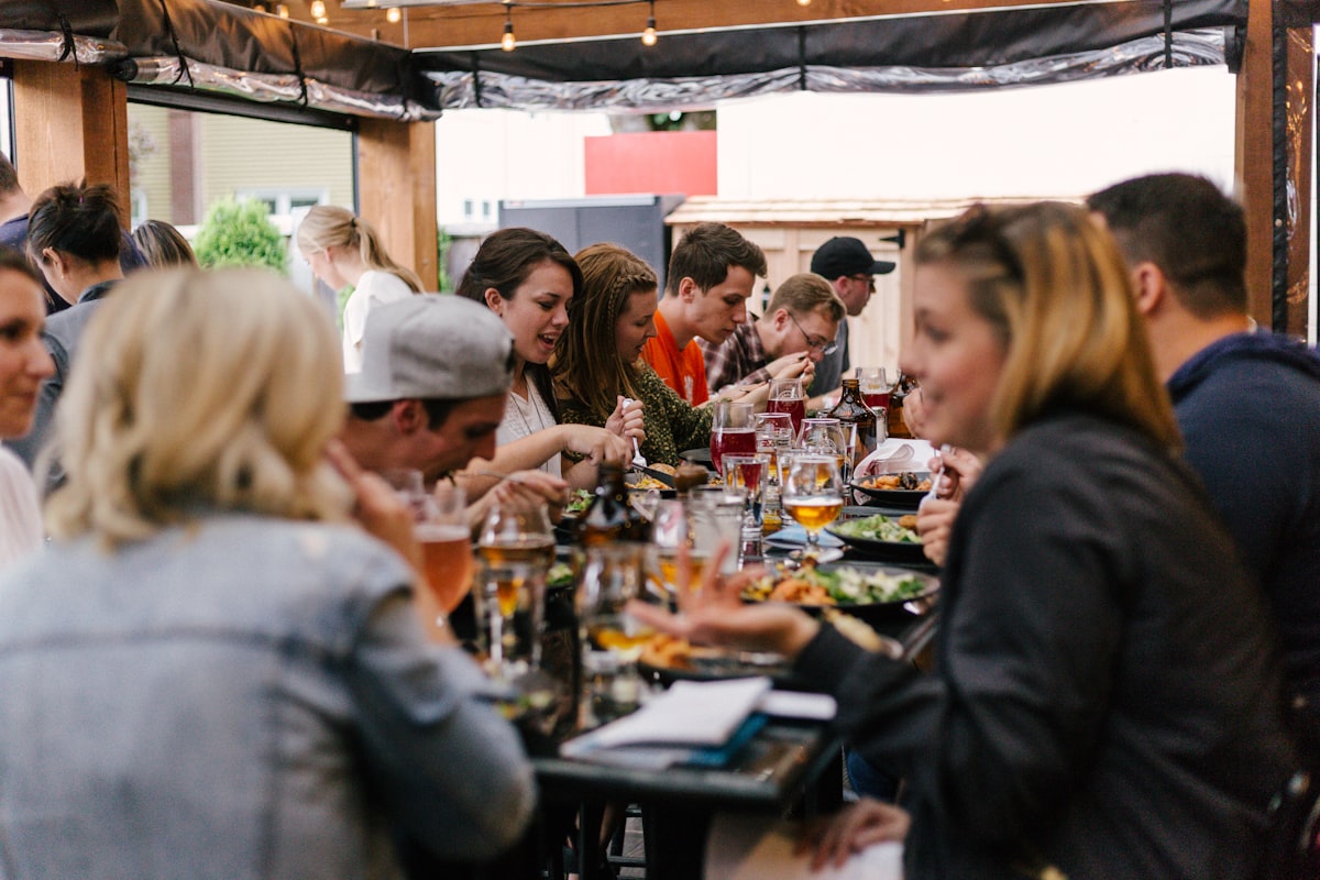 Friends sharing food around an outdoor table